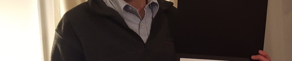 Mark holding the award